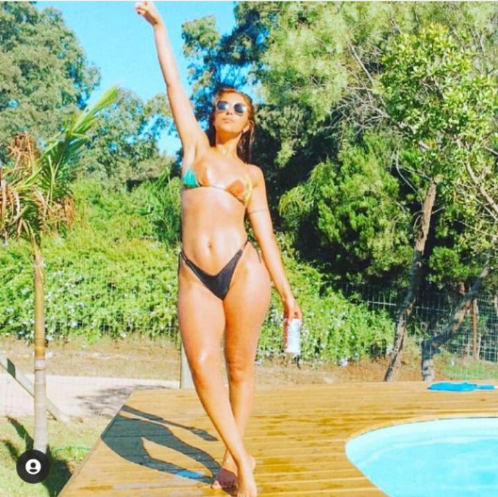 a woman in a bikini standing next to a pool at El Quincho in Punta del Este