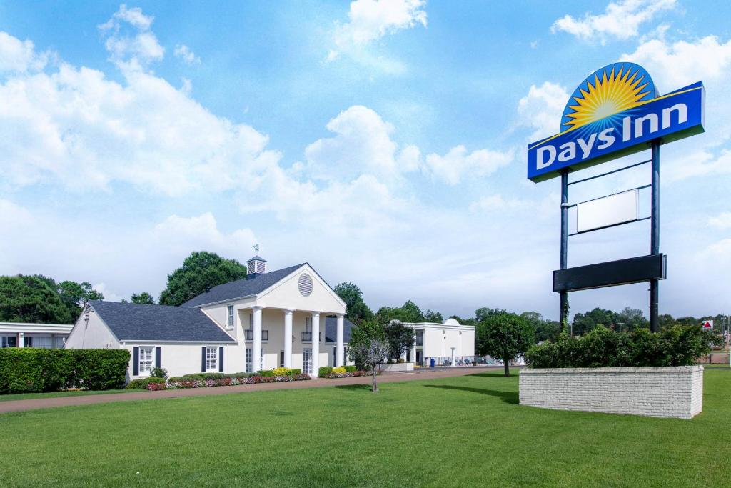 a days inn sign in front of a house at Days Inn by Wyndham Natchez in Natchez