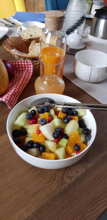 a bowl of fruit and vegetables on a table at La Ceriseraie in La Gorgue