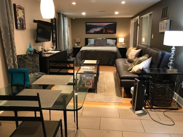 a living room with a bed and a couch at Boutique Style Apartment in the heart of SE in Portland