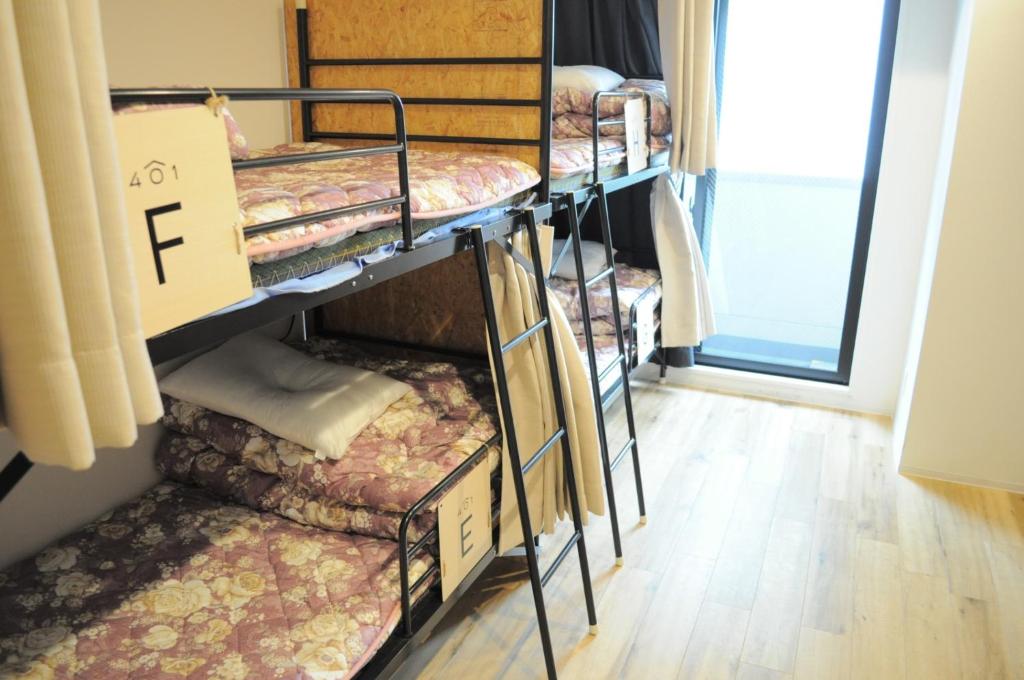 a group of bunk beds in a room at 04 village Namba - Vacation STAY 17857v in Osaka