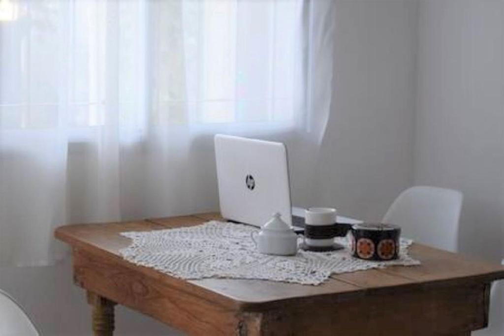 a wooden table with a laptop computer on it at Alquiler Temporario San Luis in San Luis
