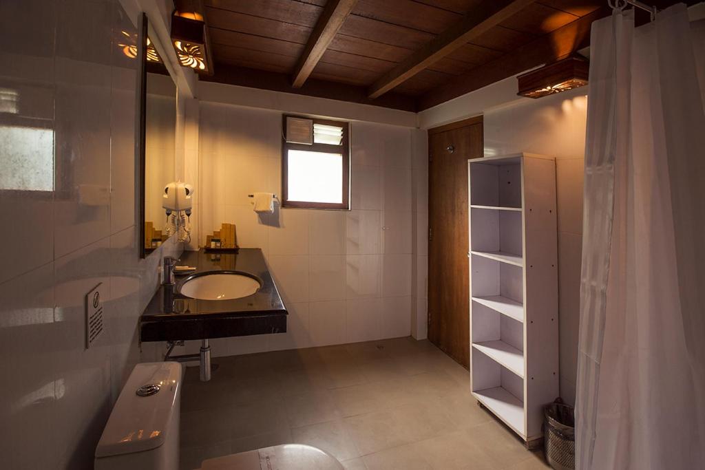 a bathroom with a sink and a mirror at Sea Shell Resort & Spa, Havelock in Havelock Island