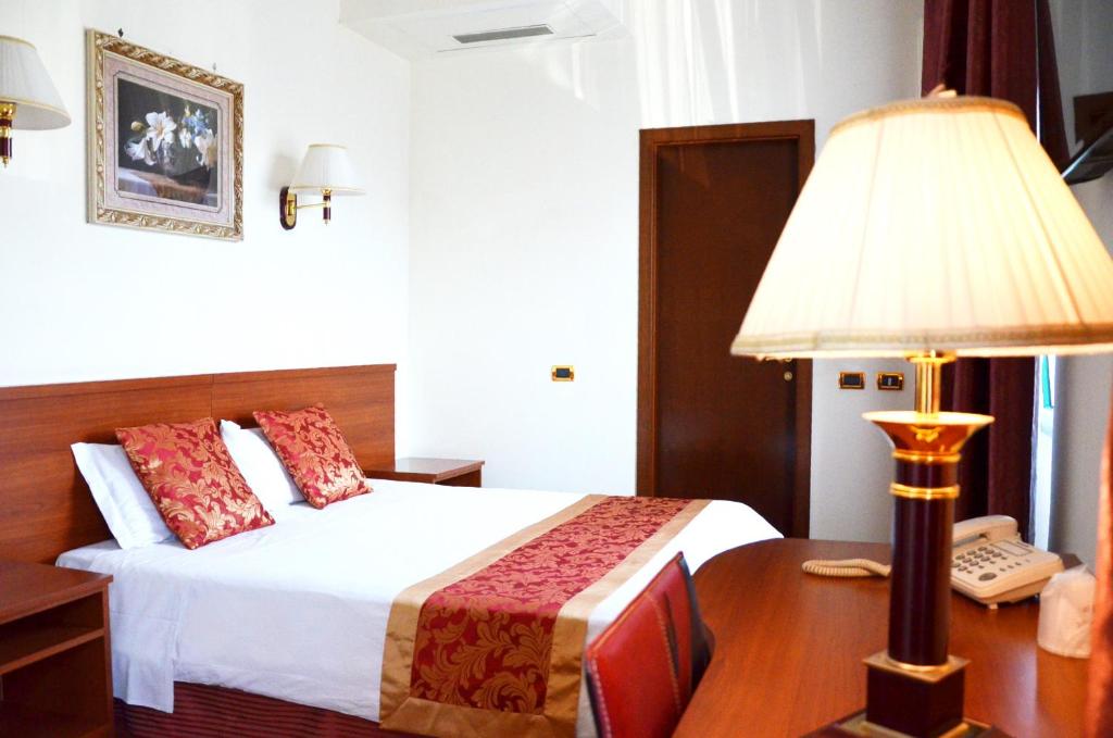 Postel nebo postele na pokoji v ubytování Hotel Geo