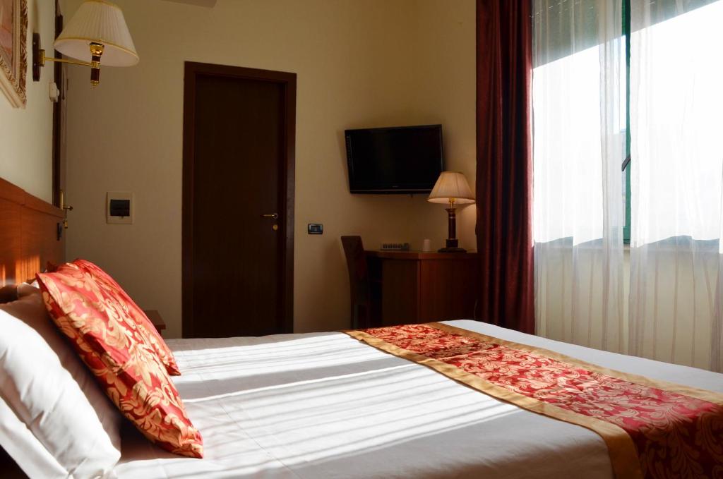 Postel nebo postele na pokoji v ubytování Hotel Geo