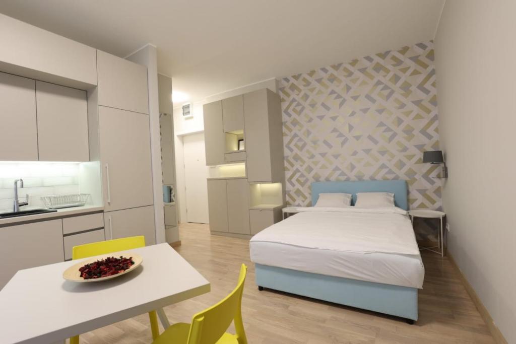 a bedroom with a bed and a table and chairs at Belgrade Center Apartment VI in Belgrade