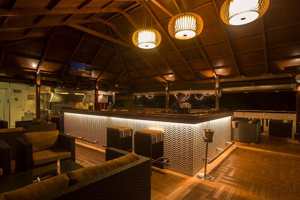 a room with a bar with a couch and speakers at Sea Shell Port Blair in Port Blair