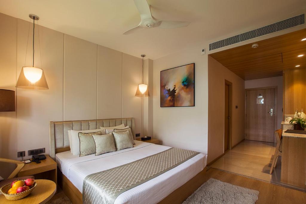 a bedroom with a bed and a bowl of fruit on a table at Sea Shell Port Blair in Port Blair
