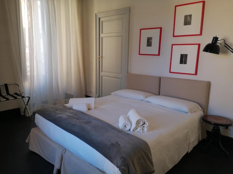 Postel nebo postele na pokoji v ubytování Palazzo Melfi