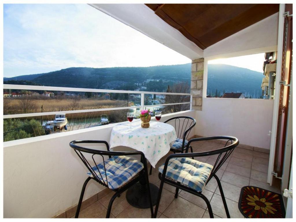 einen Tisch und Stühle auf einem Balkon mit Aussicht in der Unterkunft Villa Konalic in Mokošica