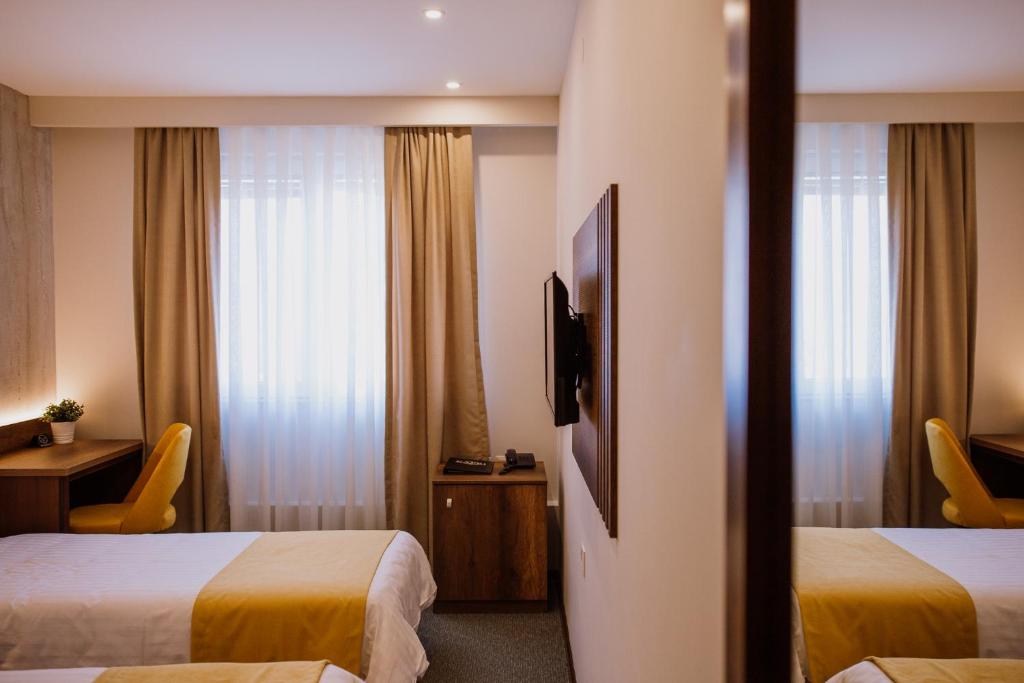 Postel nebo postele na pokoji v ubytování Hotel Kapri
