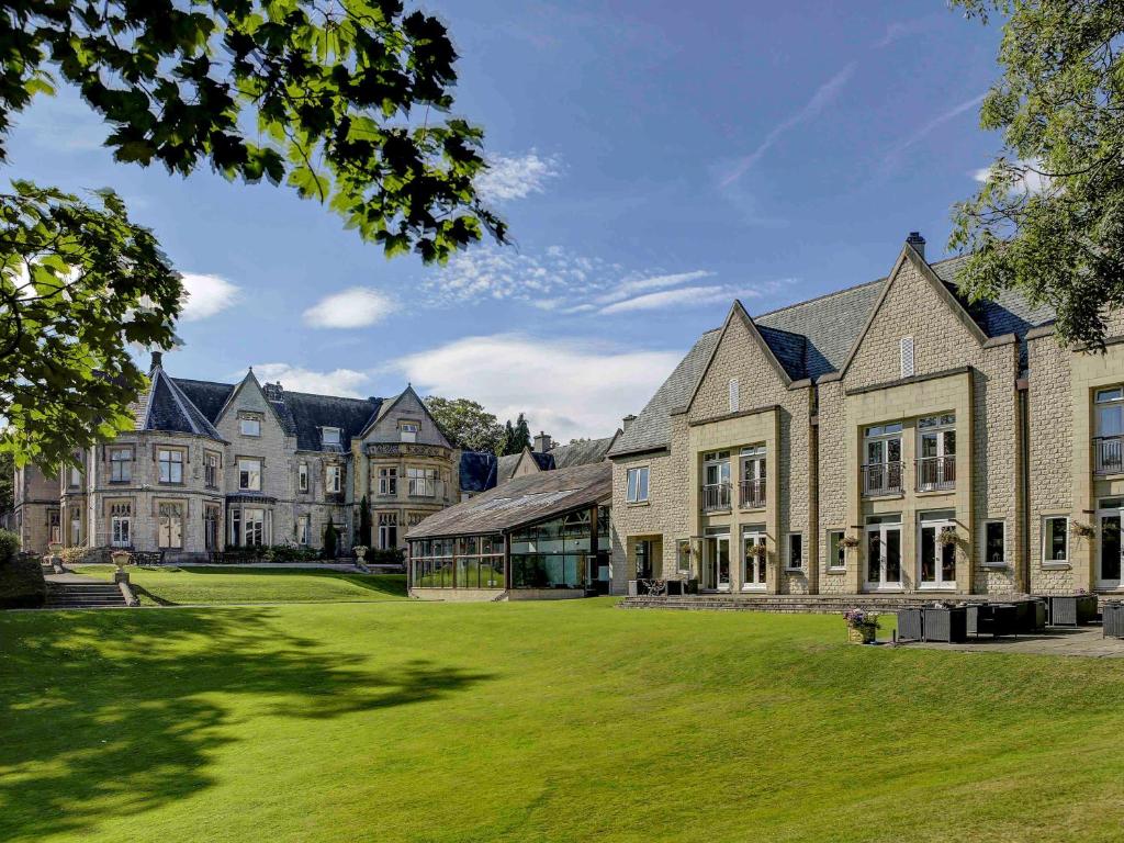 an exterior view of a large house with a lawn at Mercure Sheffield Kenwood Hall & Spa in Sheffield