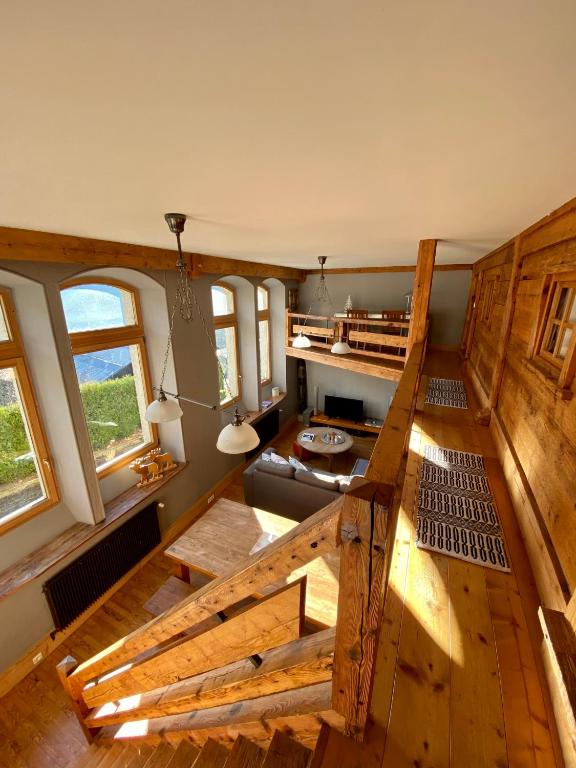 an overhead view of a living room with a bed and windows at Ancienne école du Mont in Servoz