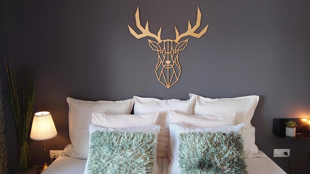 a bedroom with a bed with a deer head on the wall at Carmen Rooms -- Boutique B&B by the sea in Nerja