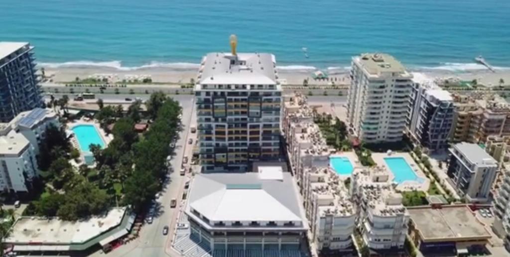 an aerial view of a beach with buildings and the ocean at Konak Tower sea view apartment 47 in Alanya