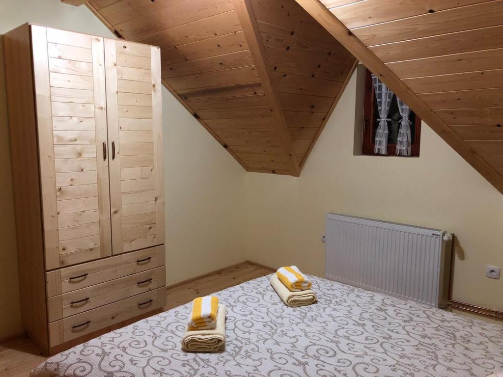 a bedroom with a bed with two candles on it at Apartmani Sredojevic in Kaludjerske Bare