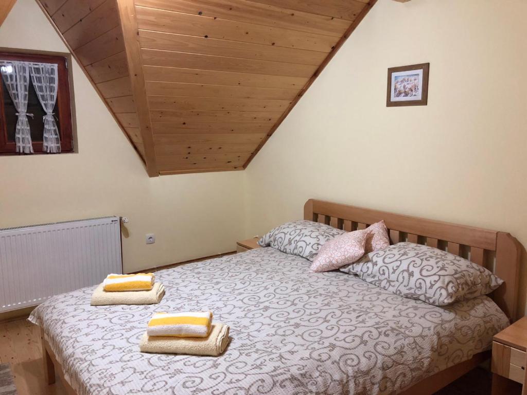 a bedroom with a bed with two pillows on it at Apartmani Sredojevic in Kaludjerske Bare