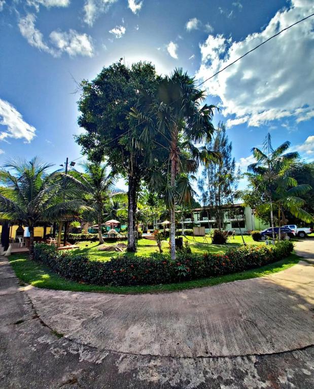 a park with palm trees in the middle of a street at Hotel Jardim Tropical in Barcarena