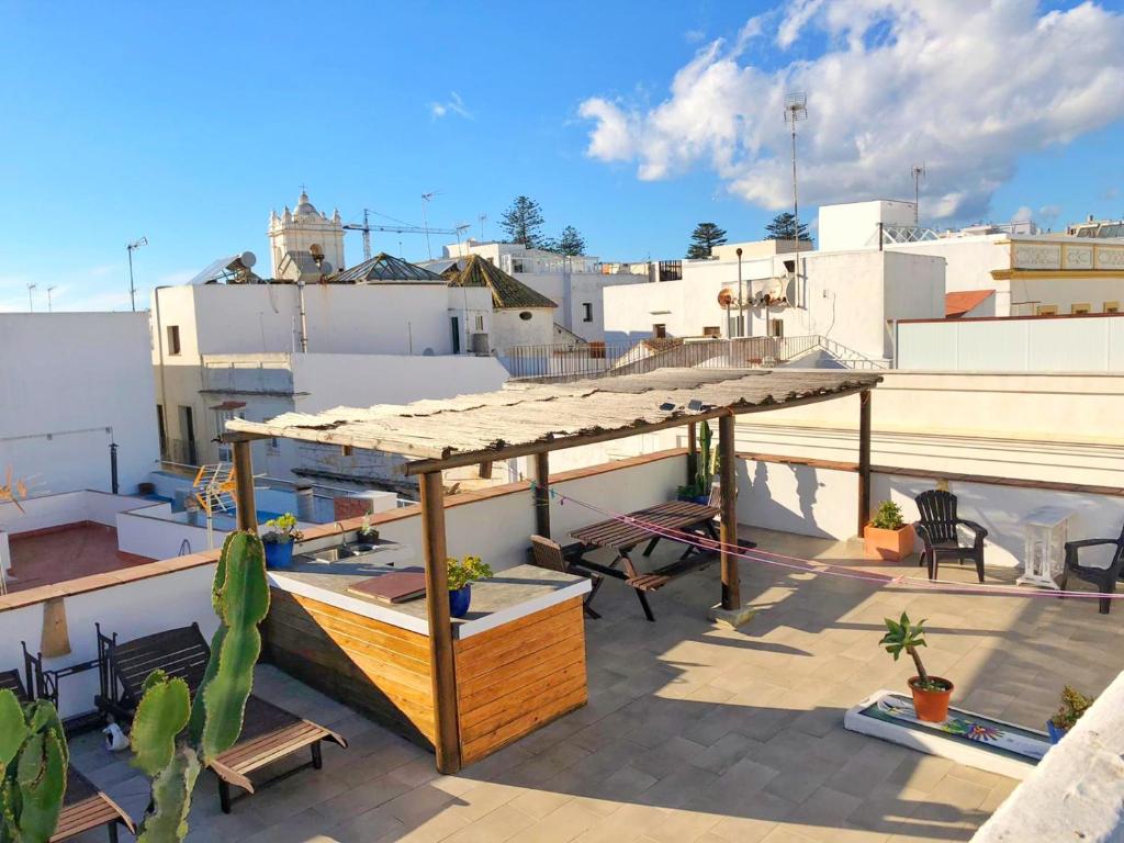 a roof top with a wooden structure on top of a building at The RooF Garden - Downtown TARIFA in Tarifa