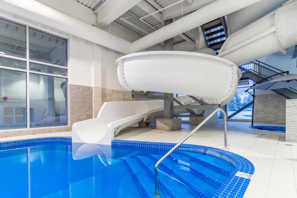 a pool chair next to a swimming pool at Canmore Inn & Suites in Canmore