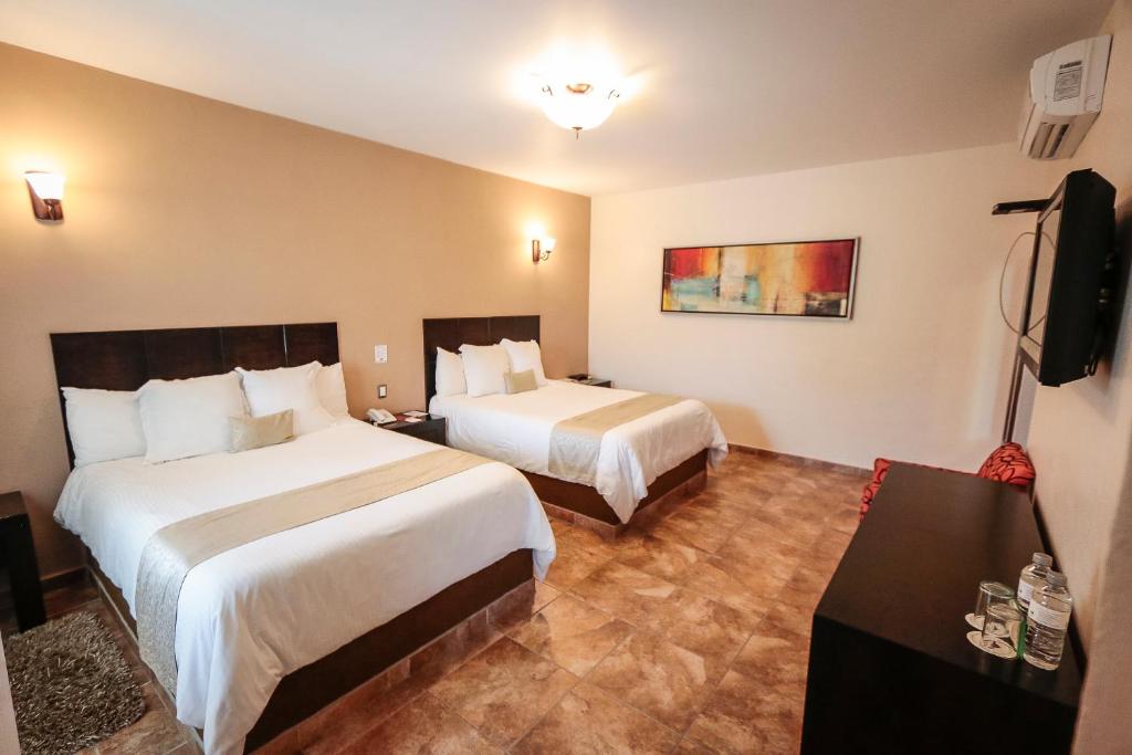Postel nebo postele na pokoji v ubytování Hotel Real de San Jose