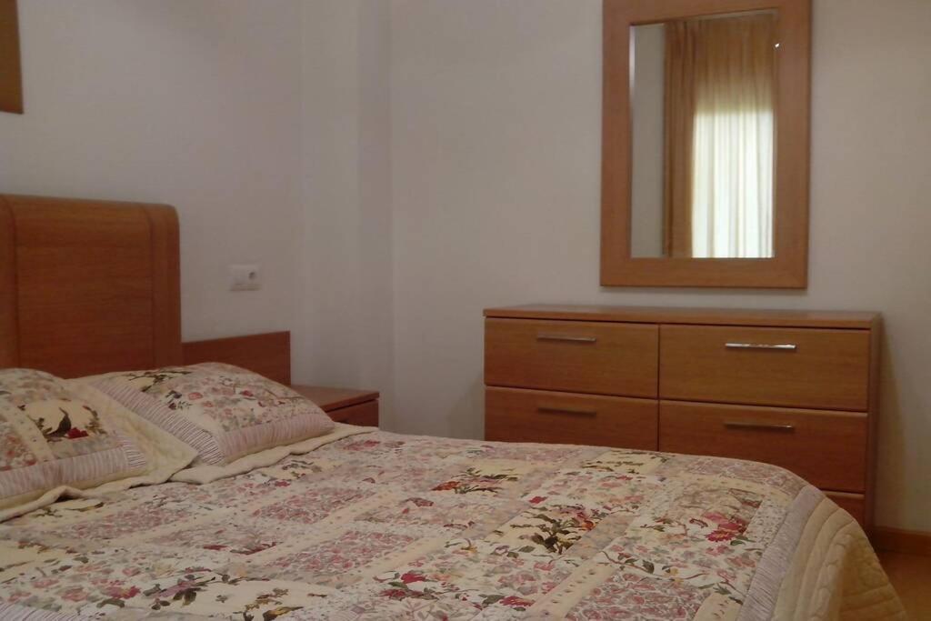 A bed or beds in a room at Bonito apartamento de 3 hab. con jardín