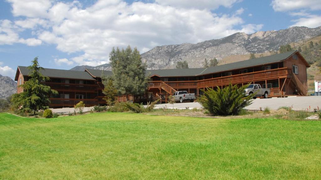 a large building with a mountain in the distance at Corral Creek Lodge in Kernville