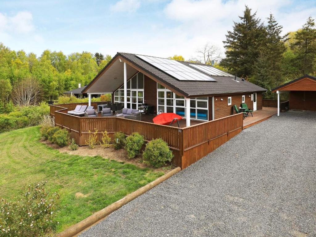 a house with a solar roof on a driveway at 8 person holiday home in Skals in Skals