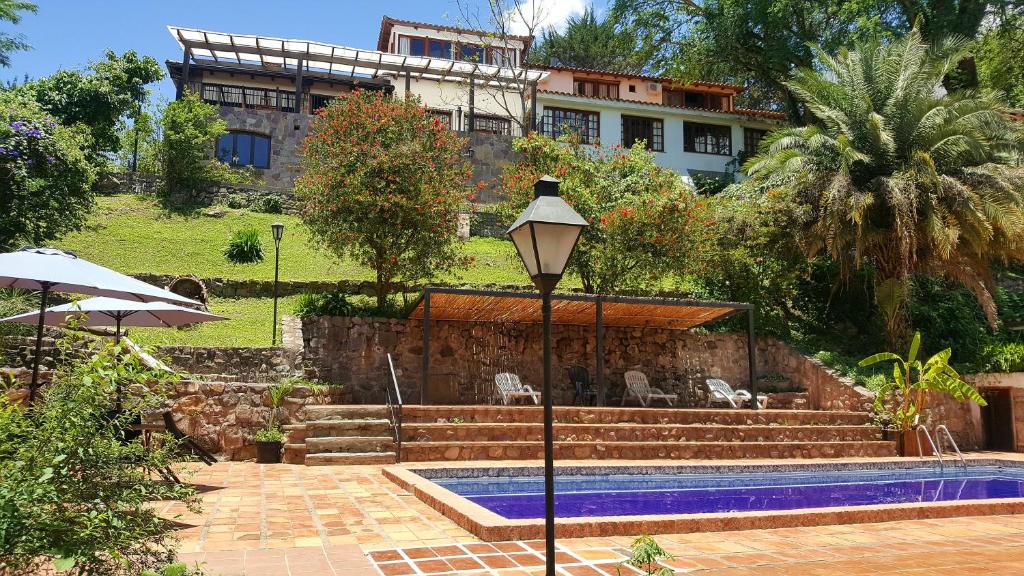 a house with a swimming pool and a street light at Hotel Selva Montana in San Lorenzo