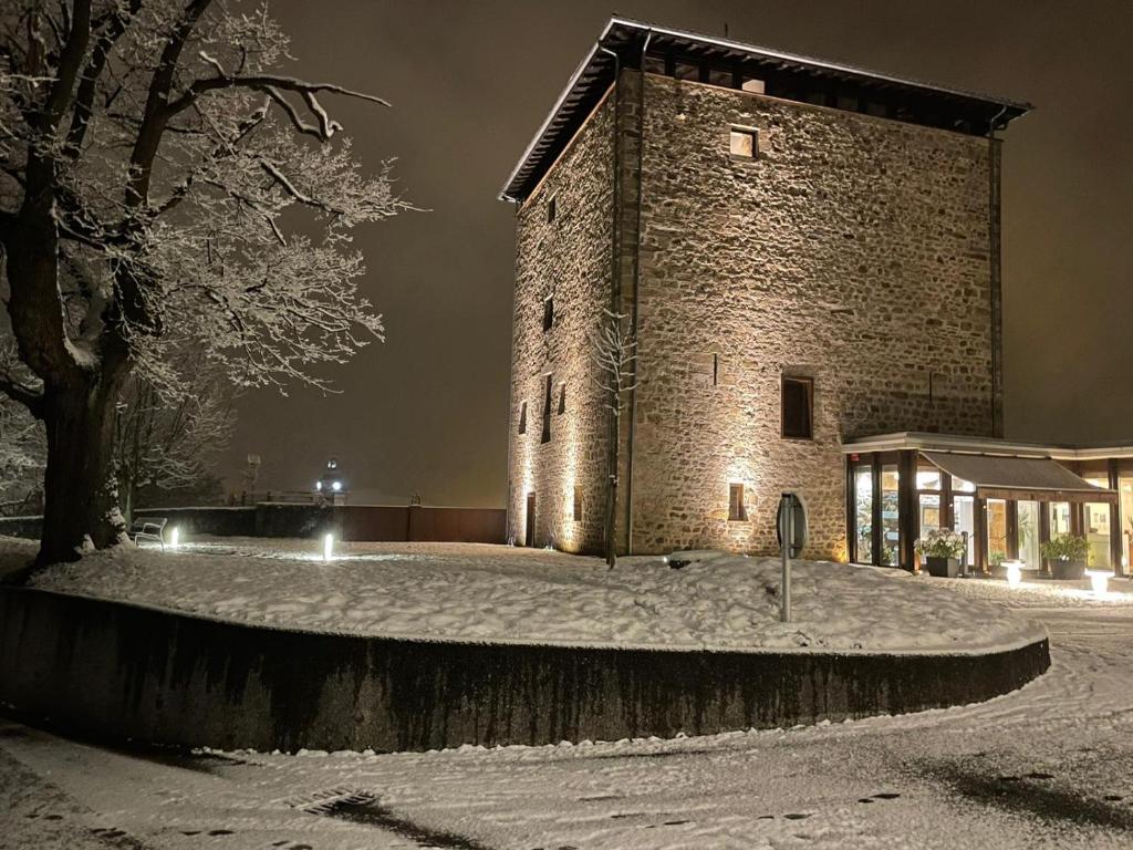 a large brick building with snow on the ground at Hotel Torre Zumeltzegi in Oñate