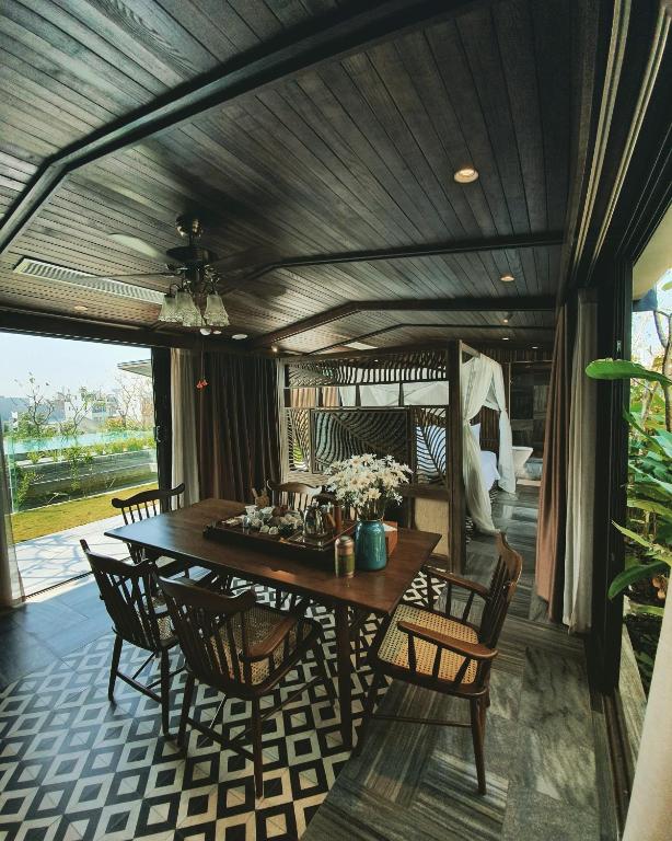 a dining room with a table and chairs at Minh Boutique in Danang