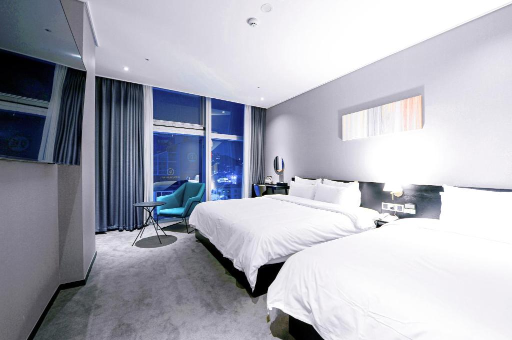 Postel nebo postele na pokoji v ubytování Ocean The Point Hotel Busan