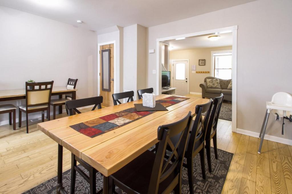 a dining room and living room with a wooden table and chairs at The Gray House by Gallaudet 4 BR 3 BA in Washington