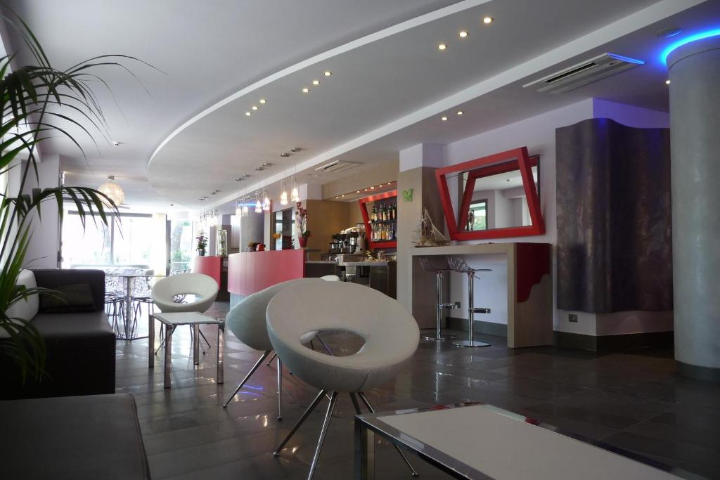 a living room with a table and some chairs at Hotel Marcus in Bellaria-Igea Marina