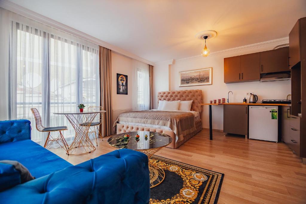 a living room with a bed and a kitchen at Wonder Suites in Istanbul