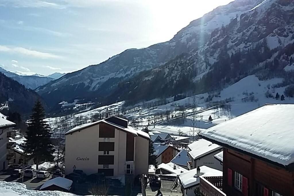 a town with snow covered buildings and a mountain at Salute 106 in Leukerbad