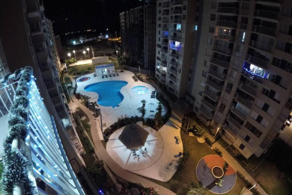 an overhead view of a pool in a city at night at Confortable apartamento en conjunto Puerto Azul Club House in Ricaurte