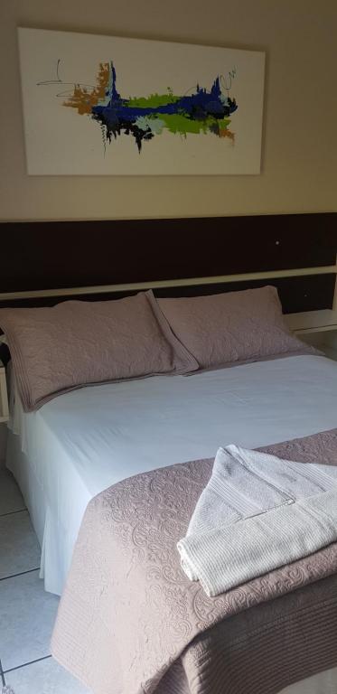 Cama ou camas em um quarto em Pousada Guaruja