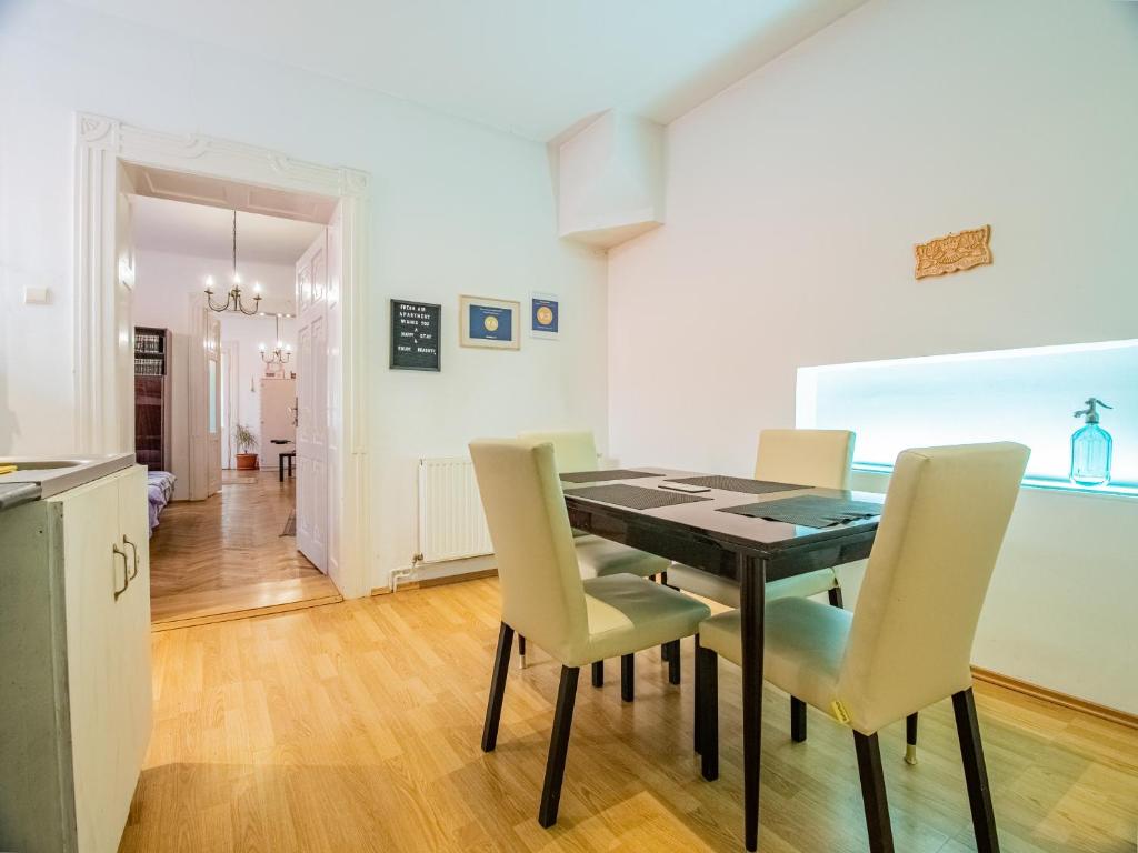 a kitchen and dining room with a table and chairs at Fresh Air Apartment in Braşov