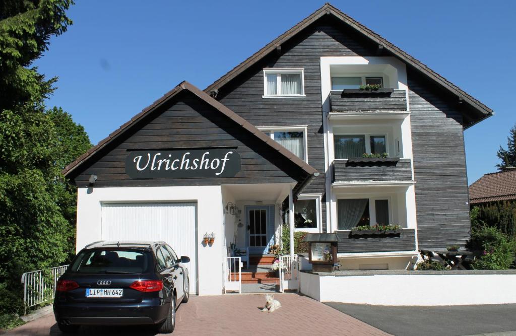 a black car parked in front of a house at Ulrichshof in Braunlage