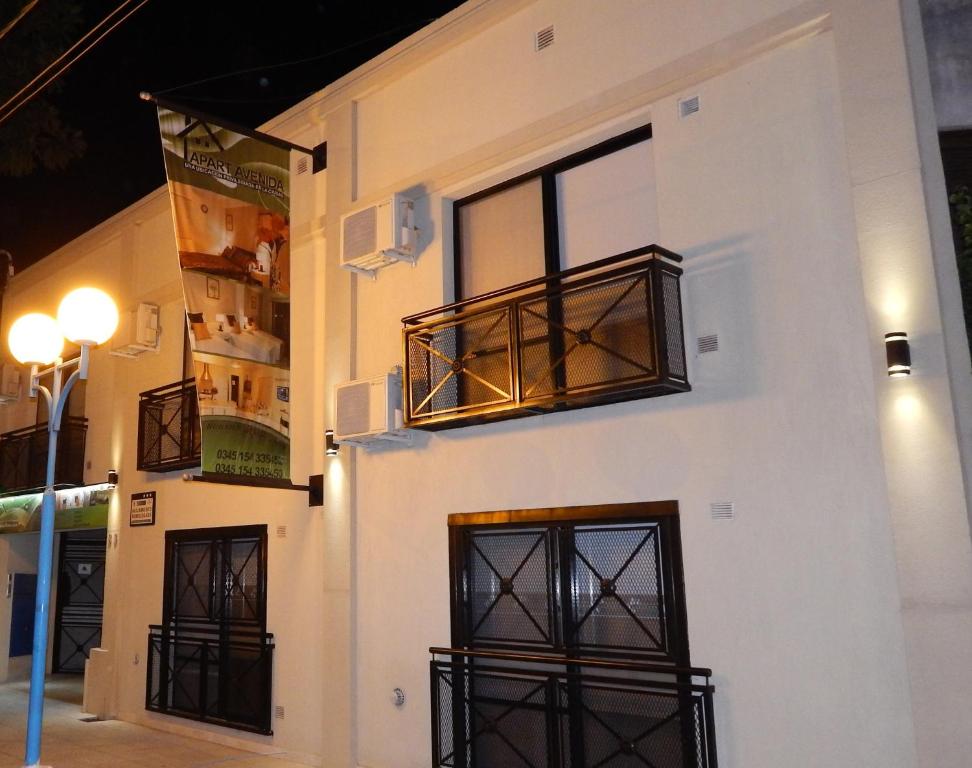 a white building with windows and a balcony at Apart Avenida in Concordia