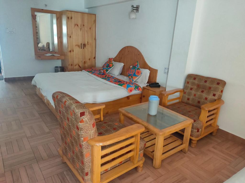 Postel nebo postele na pokoji v ubytování Hotel BHRIGU