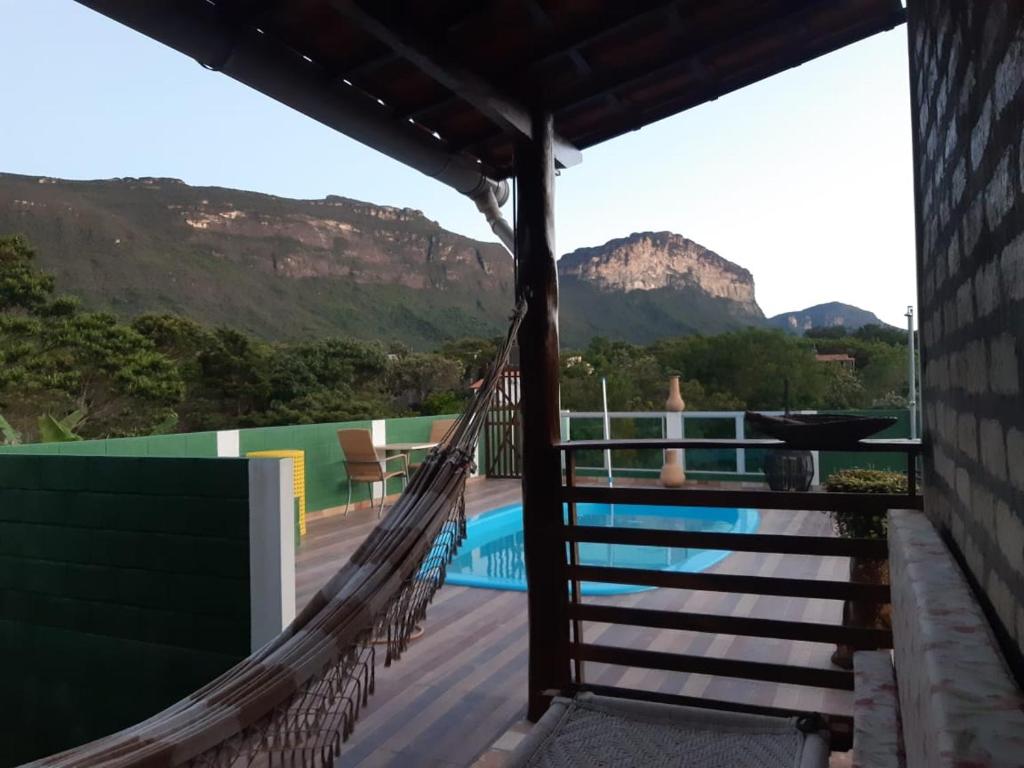 a hammock on a house with a view of the mountains at Vyzuh Guest House in Vale do Capao