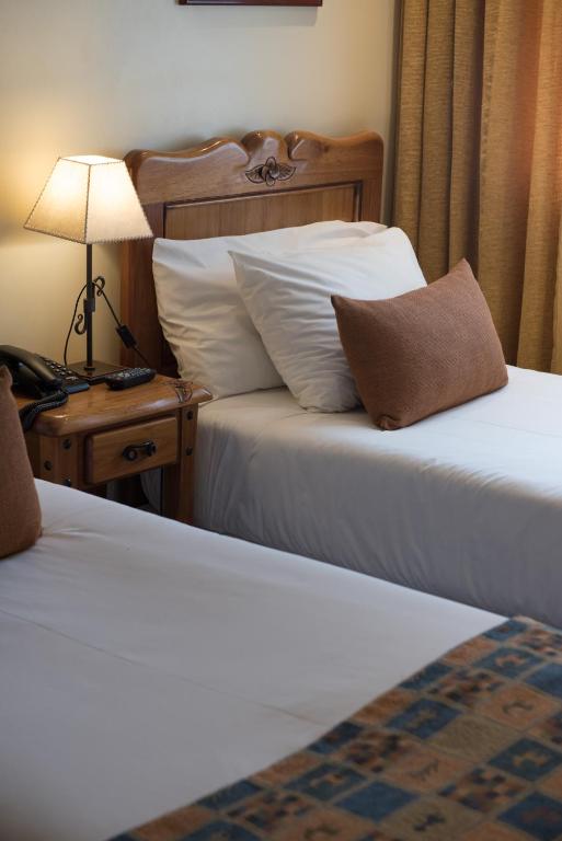Postel nebo postele na pokoji v ubytování Del Bosque Apart Hotel