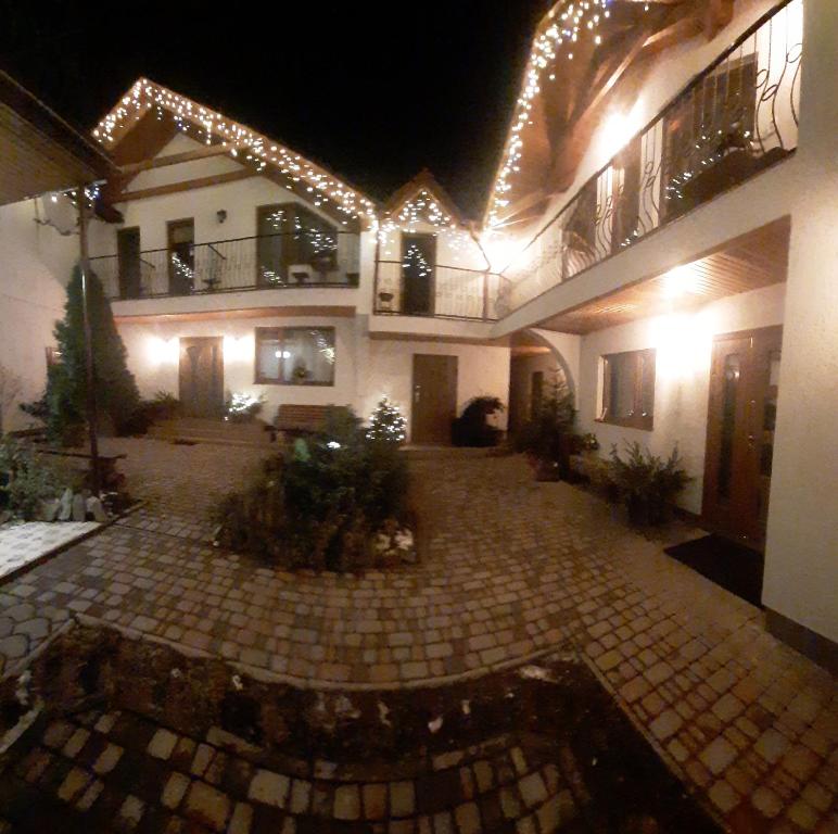 a large building with a courtyard at night at U Slavika in Yasinya