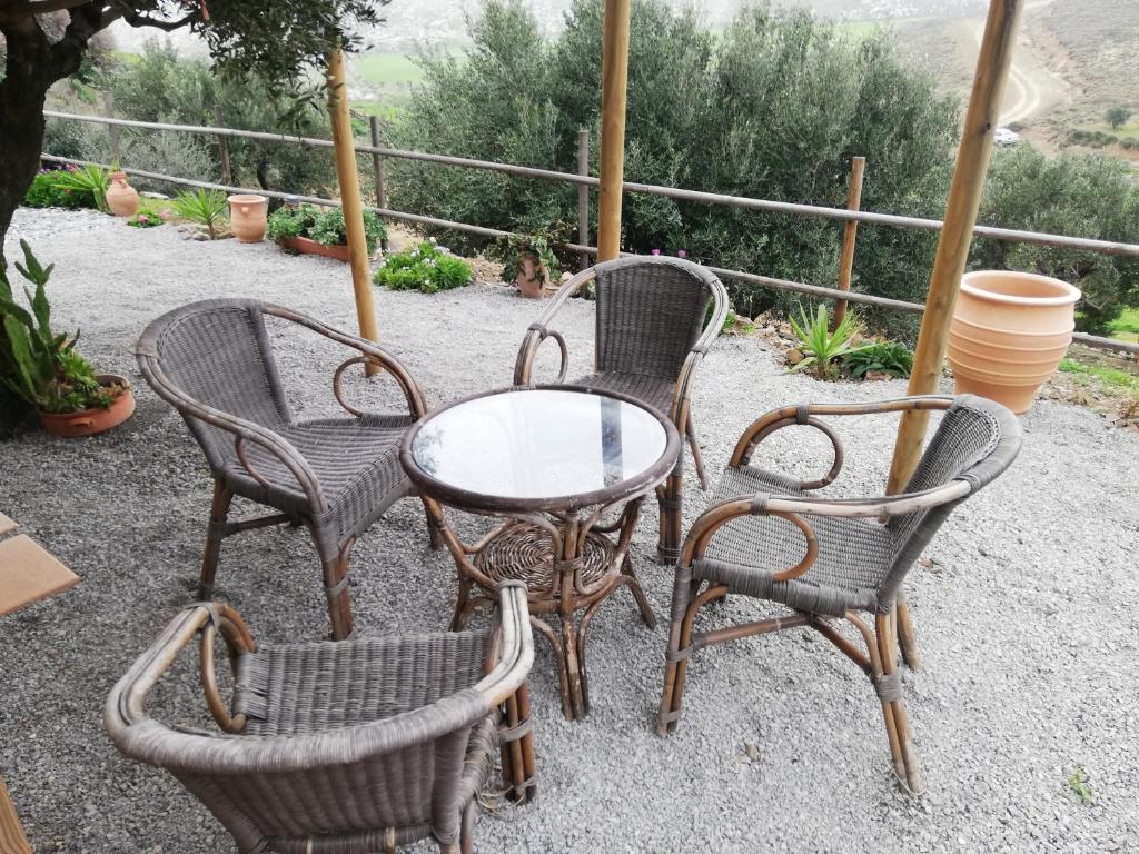 a group of chairs and a table and a table and chairs at Wooden House at the Mountain-private in Paránimfoi