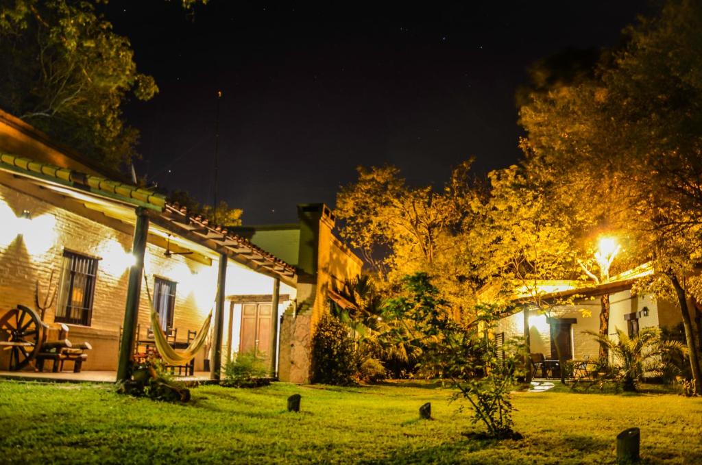 a house with a lit up yard at night at Golden Lodge in Paso de la Patria