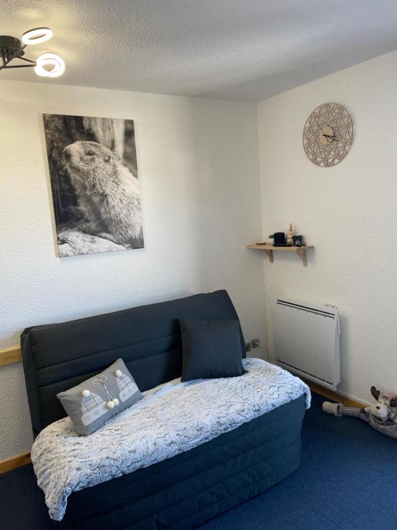 um quarto com uma cama azul e um pássaro na parede em L'AnsloBoys Montagne H2 em Les Deux Alpes