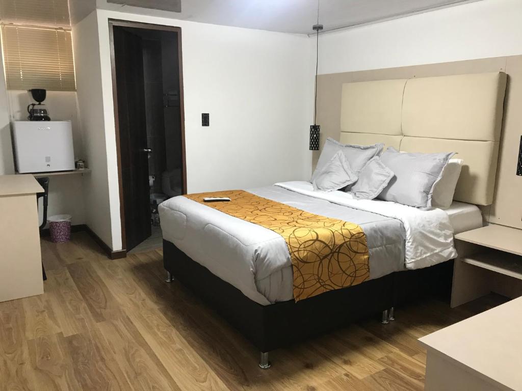 Postel nebo postele na pokoji v ubytování Hotel Casa Modelia