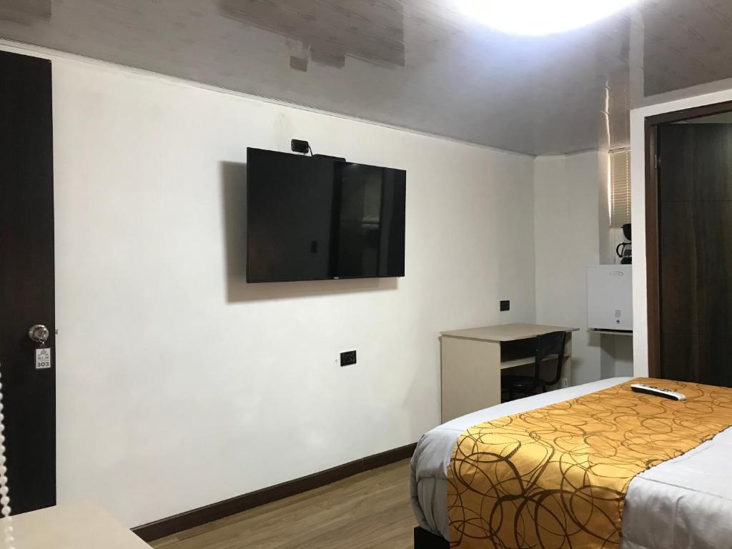 Postel nebo postele na pokoji v ubytování Hotel Casa Modelia